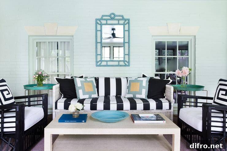 Sunroom with teal tray tables and black-and-white cushions