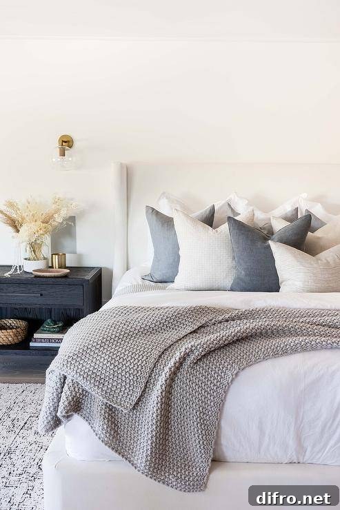 Bedroom with white bed and dark gray accent pillows