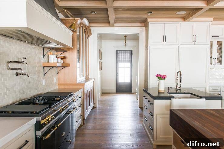 Cottage kitchen with side-by-side islands, Shaker cabinets and a black range