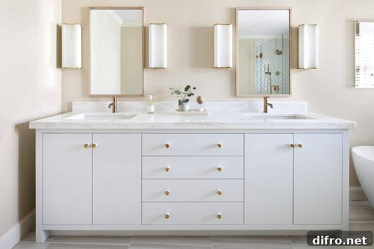 White and gold bathroom with dual washstand and marble countertop