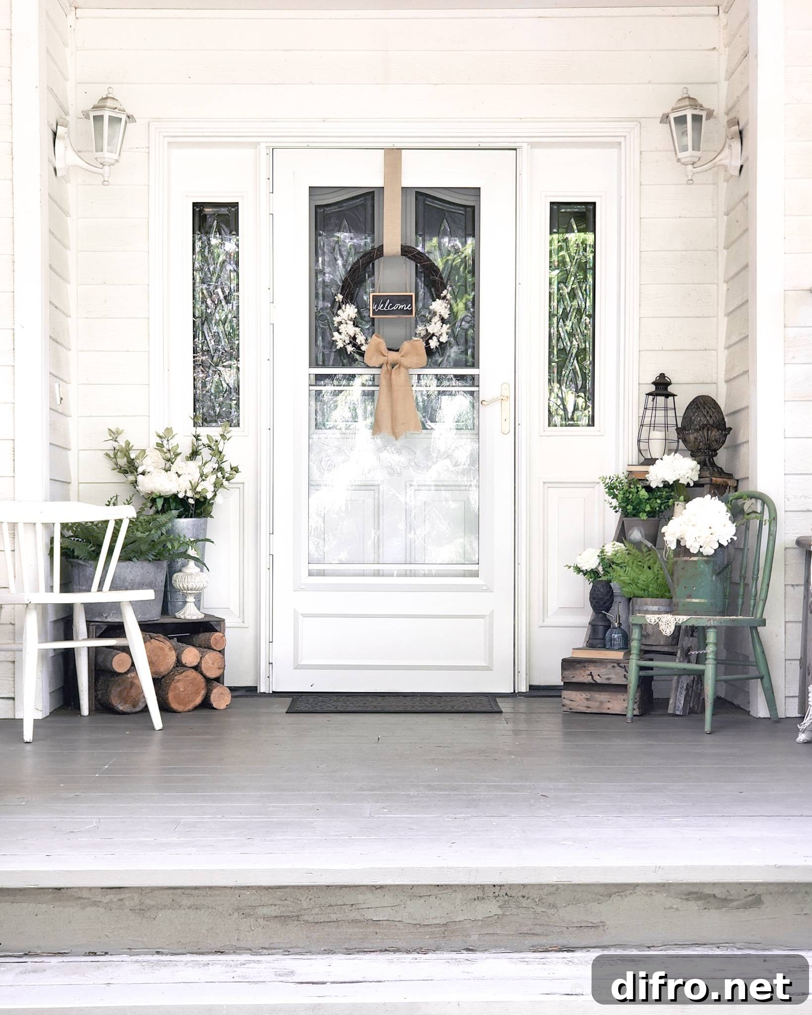 white front porch design with symmetrical chairs and plants surrounding entrance