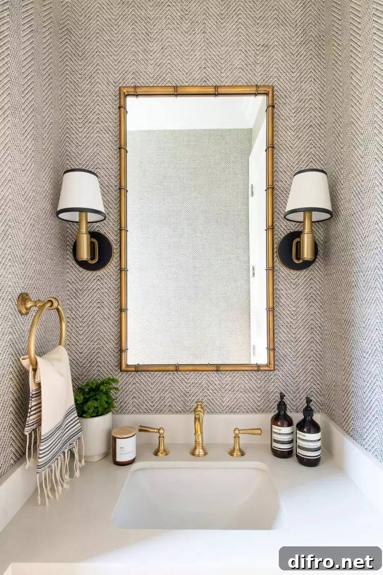 beige textured wallpaper surrounding bathroom vanity with gold and black accents