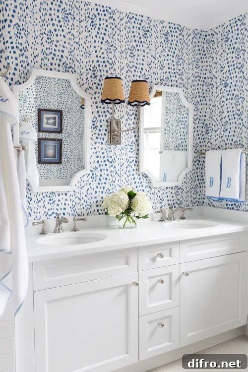 bright blue patterned wallpaper in all white bathroom