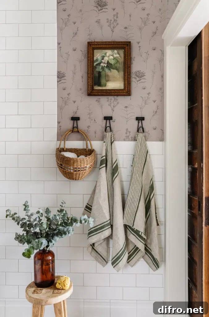 light floral wallpaper surrounding white subway tiles in bathroom