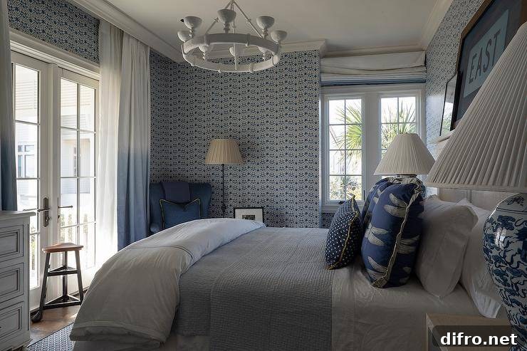 Bedroom with wooden headboard, blue patterned wallpaper and a white chandelier