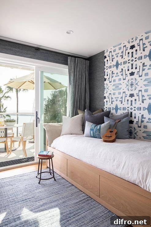 Custom daybed against an accent wall with blue trellis wallpaper
