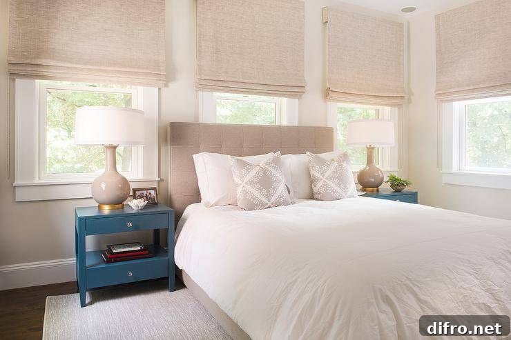 Neutral boho bedroom with beige tufted headboard and layered pillows.