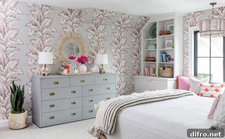 Welcoming pink and gray bedroom with patterned wallpaper and a cozy window seat.