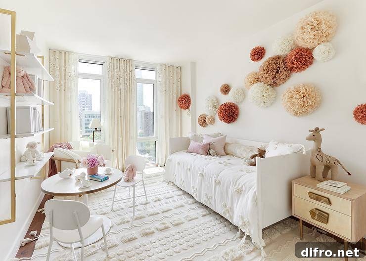 Boho bedroom with paper pom poms over a white daybed and textured rug.