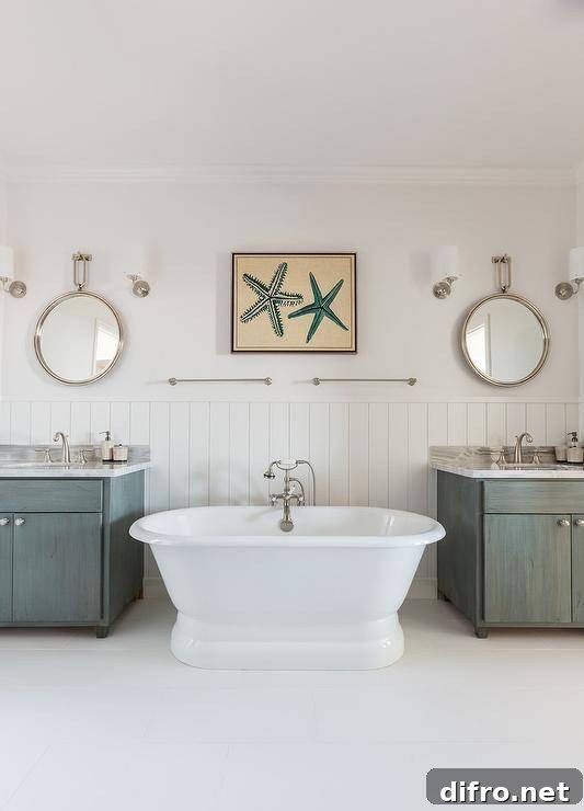 Cottage kids' bathroom features upper walls painted a creamy white and lower walls clad in vertical shiplap lined with a freestanding tub paired with a vintage style tub filler under side by side towel rails.