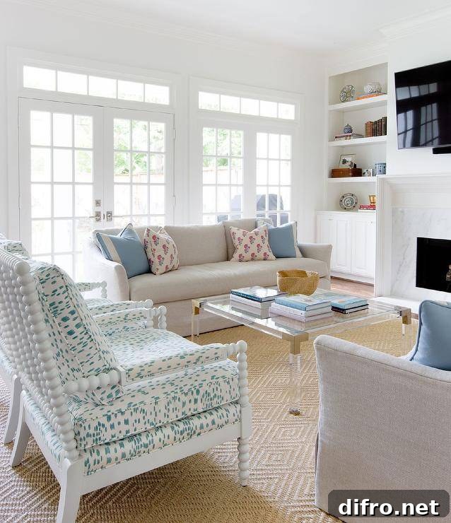 Welcoming living room boasts white spindle chairs and a lucite coffee table finished with brass corners