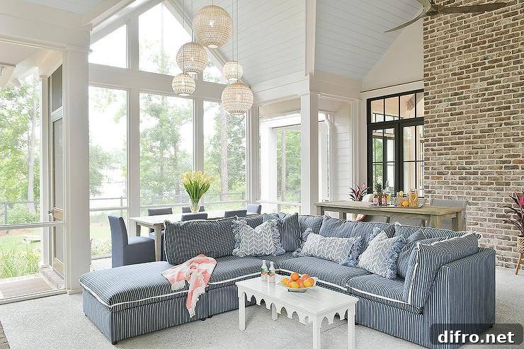 Living room features a blue striped sectional with white scalloped coffee table
