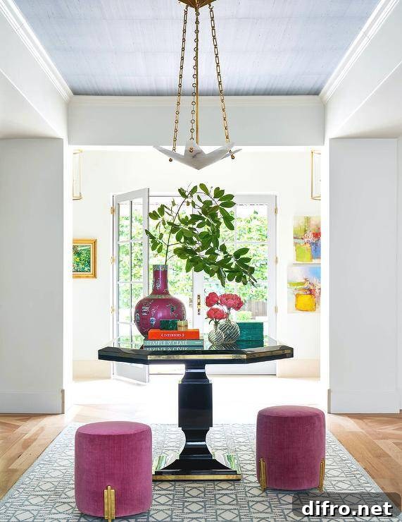 Gold and black octagon table paired with fuchsia stools placed on a white and blue rug.