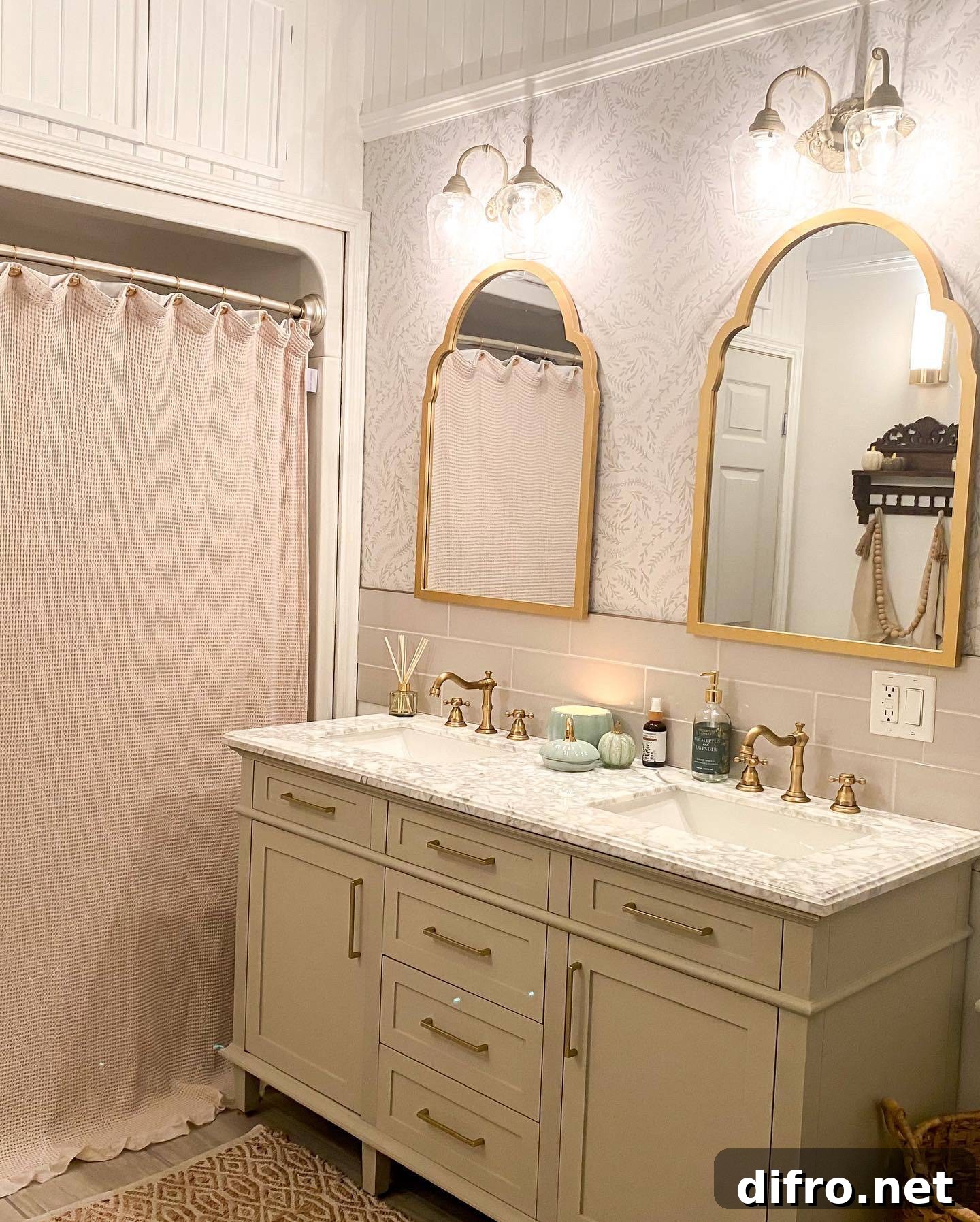 Double vanity bathroom sink with gold fixtures and white cabinets, patterned marble top.