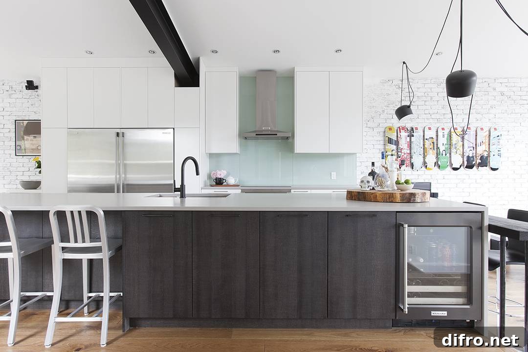 black kitchen island against white cabinets with aquamarine backsplash
