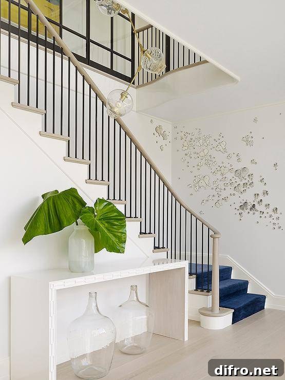 Eclectic foyer with blue velvet runner and distinctive railing accents.