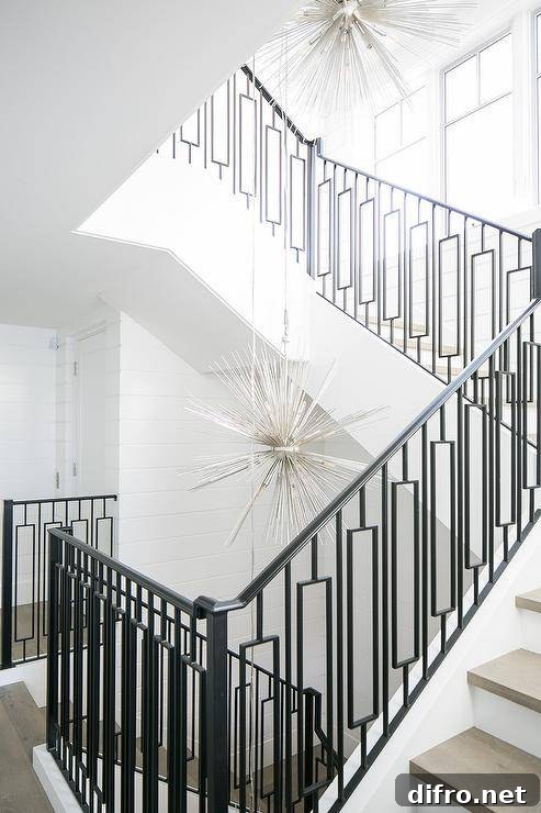 Staircase fitted with wrought iron spindles and gray treads.