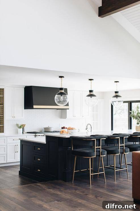 Black velvet stools at a black island with white quartz