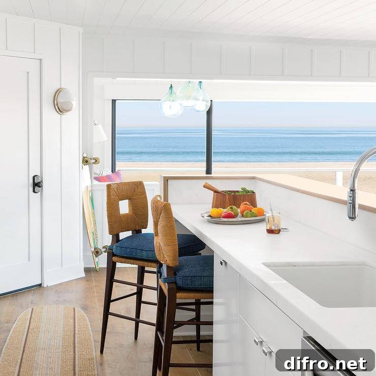 Abaca stools with blue cushions sit at a white kitchen island finished with a sink and polished nickel faucet mounted in front of a wood top breakfast bar.