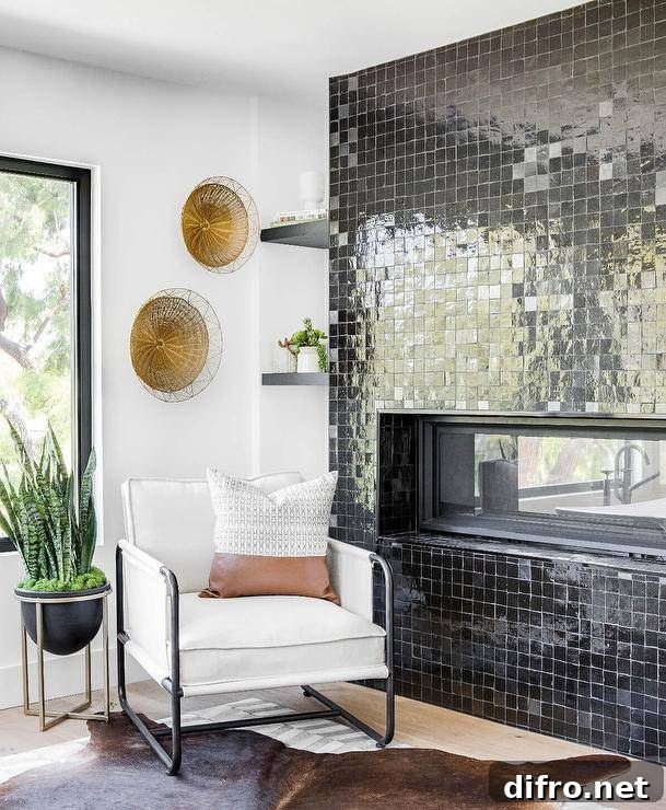 Living room features a modern fireplace with black glazed grid tiles and a white accent chair.