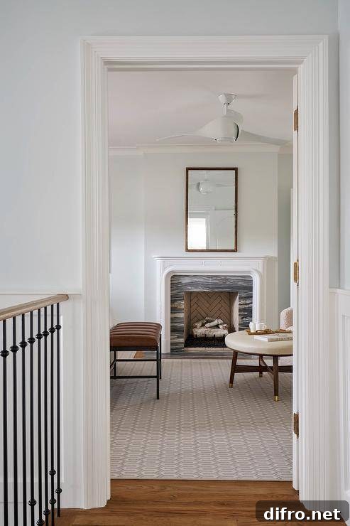 A bamboo mirror is mounted over an original fireplace with black marble surround and brown leather bench.