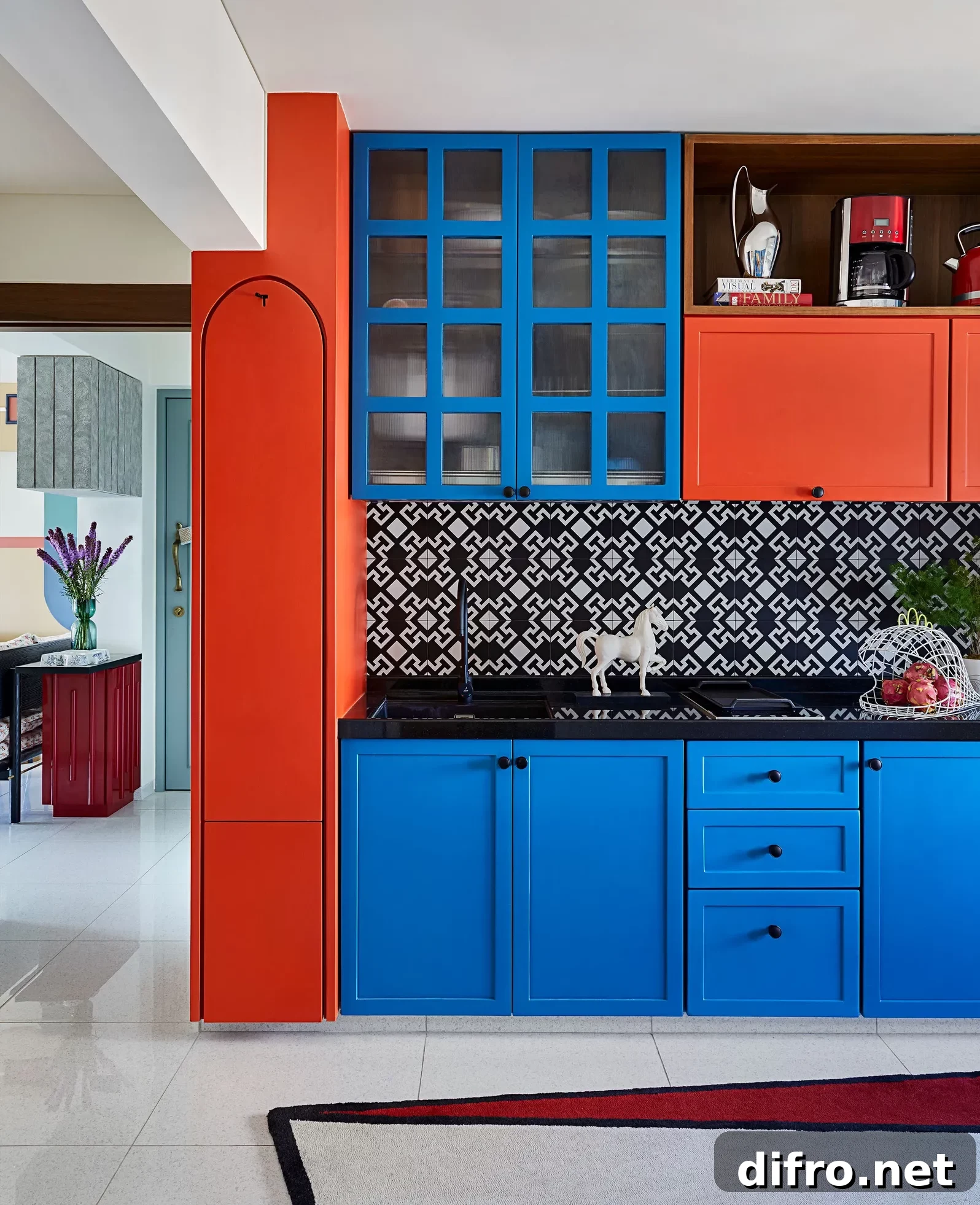 electric blue and red kitchen cabinets with black accents, white & black patterned backsplash