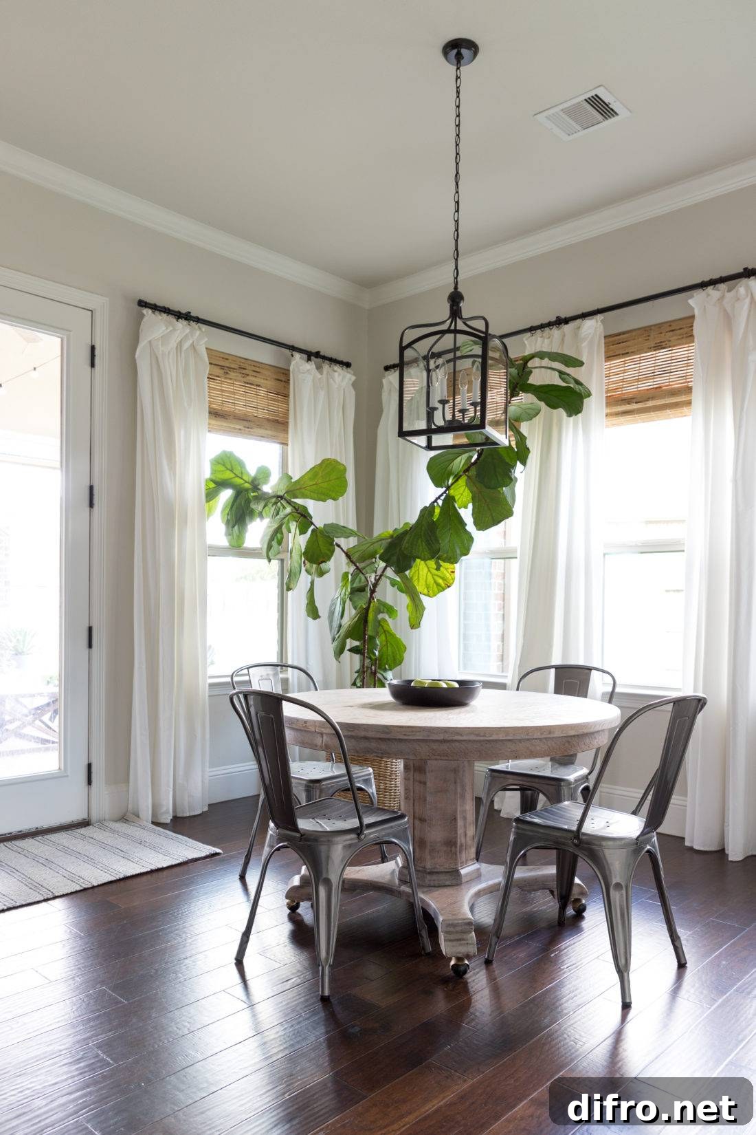 Contrast between industrial chairs and a round wooden table
