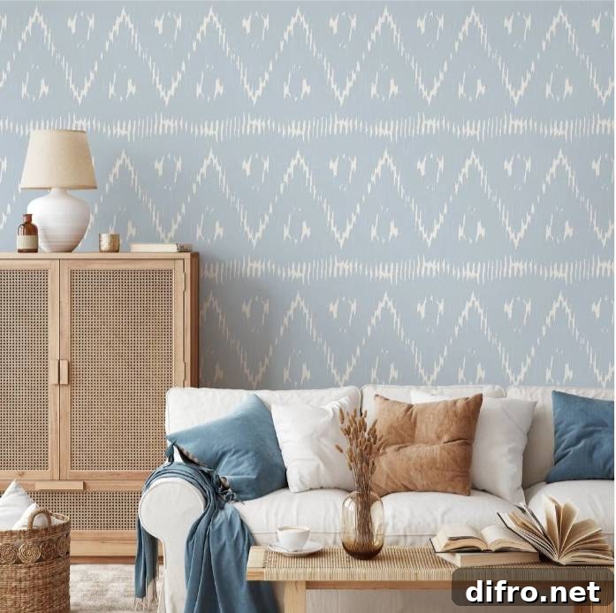 Living room where a solid camel sofa balances patterned wallpaper