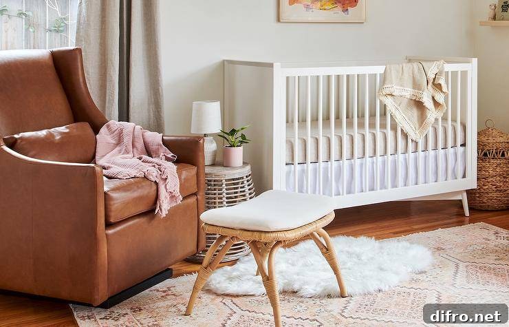 Vintage nursery with a leather glider and rattan stool beside a white crib on a pink and gray rug.