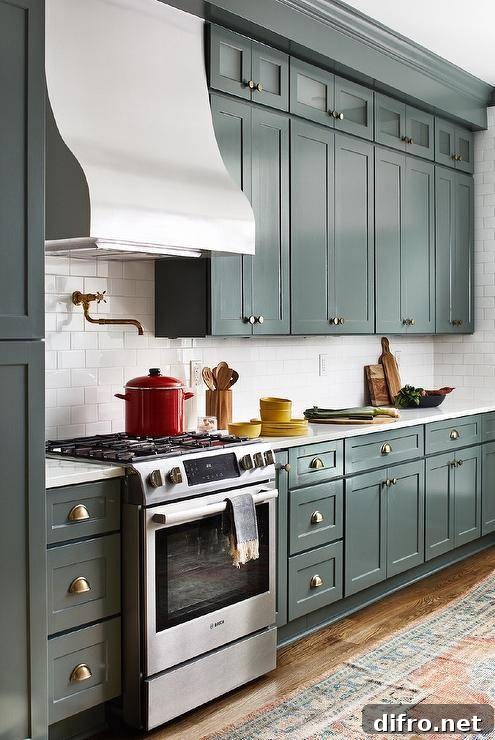 Transitional kitchen with mixed metals and a pot filler above a stove