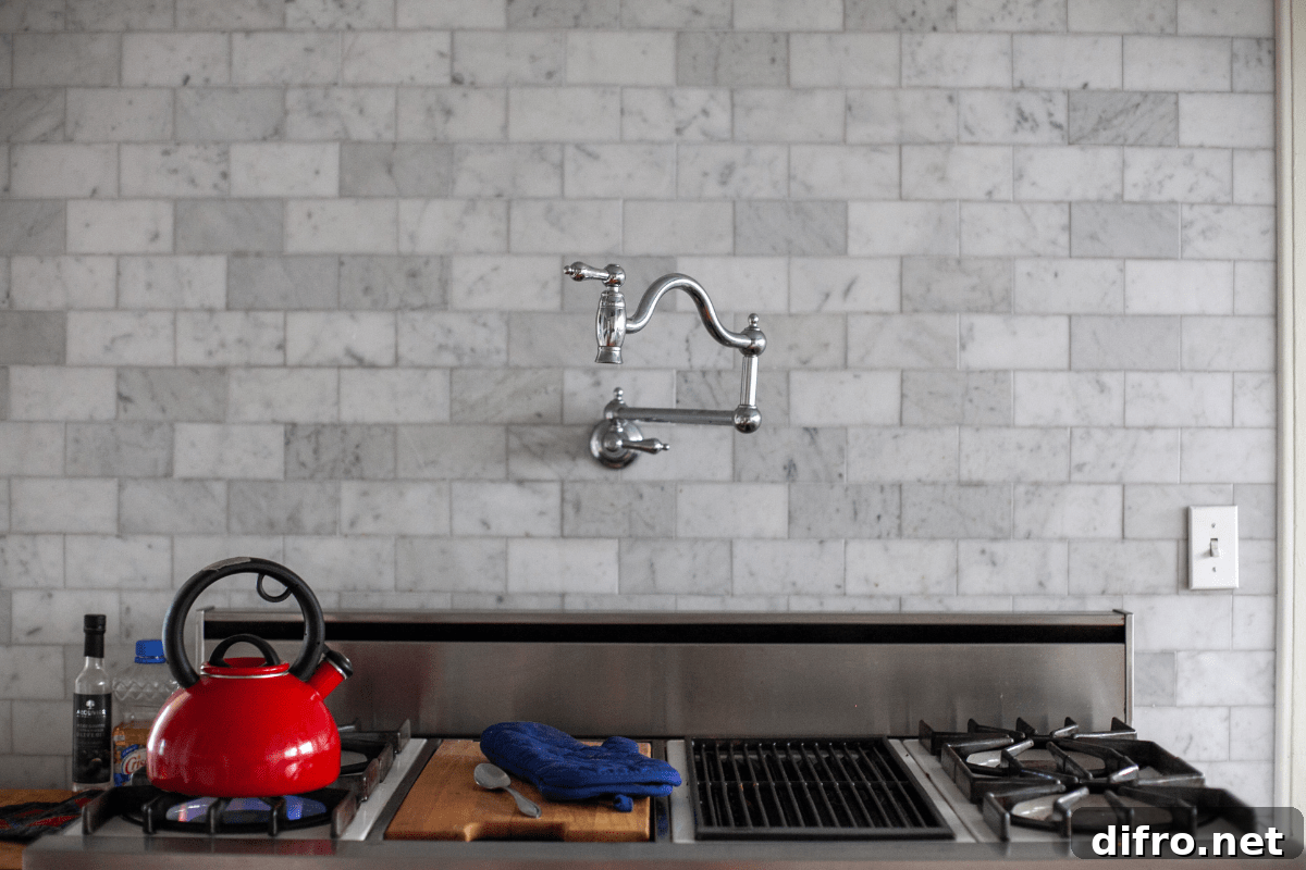 Gray marble backsplash with a pot filler above the stove