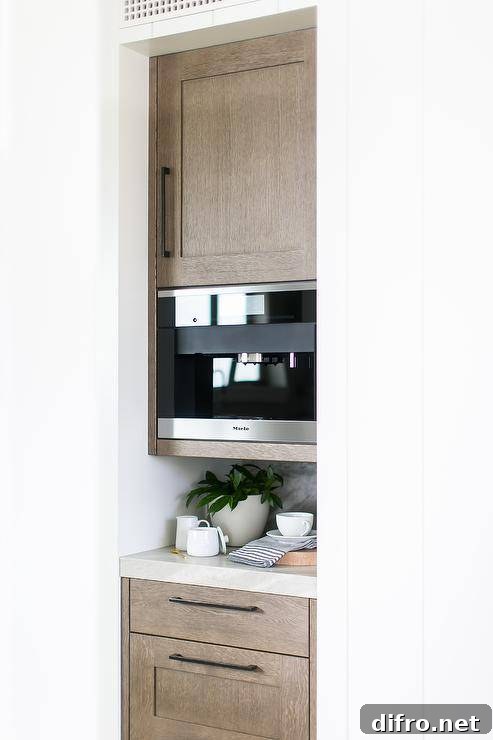 Miele coffee machine built-in a kitchen nook coffee station between brown oak cabinets.
