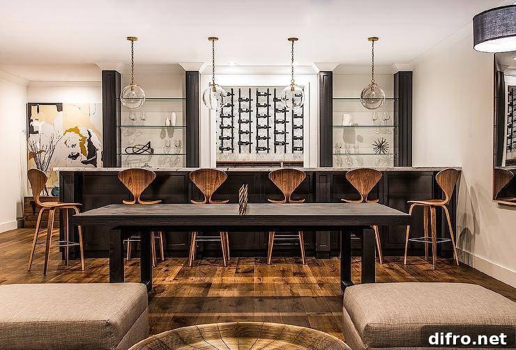 Black wet bar topped with white marble, glass globe pendants, and vertical wine racks.