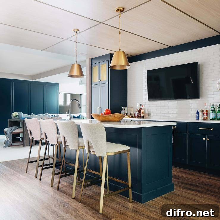 Blue shaker wet bar island with white quartz countertop and brass lanterns.