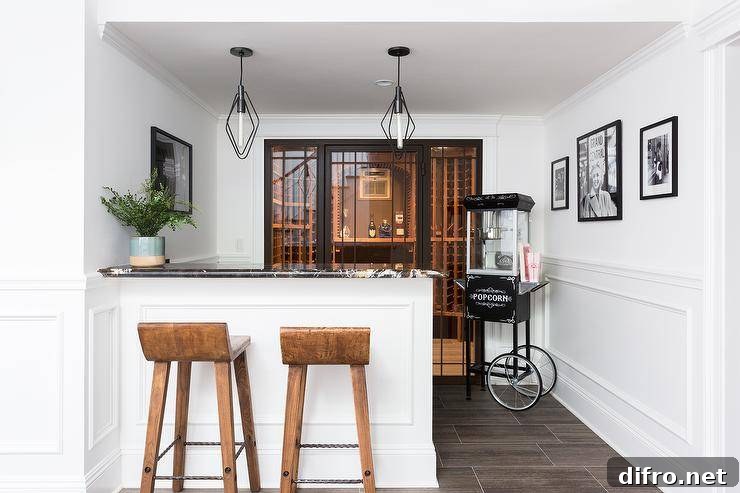 Basement wine area with white peninsula and rustic wooden barstools under pendant lights.