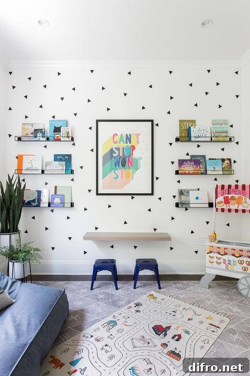 Floating kids' desk on a white wall with blue tolix stools and black triangle decals as a fun accent.