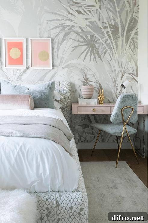 Pink wall-mounted desk used as a bedside table in a bedroom with a gray chair and pink accent pillow.