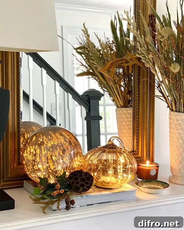 A fall entryway with pumpkins that have lights.
