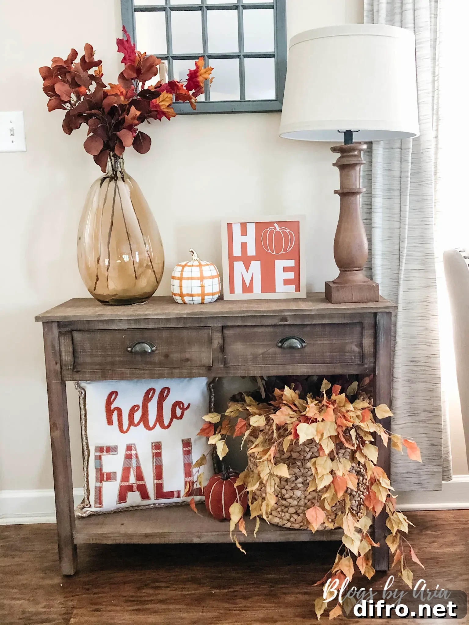 Fall entryway with a pillow with writing that reads hello FALL.