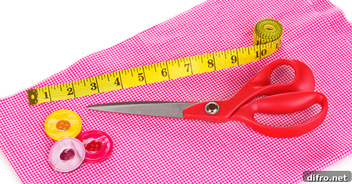 Tape measure and scissors on textured fabric.