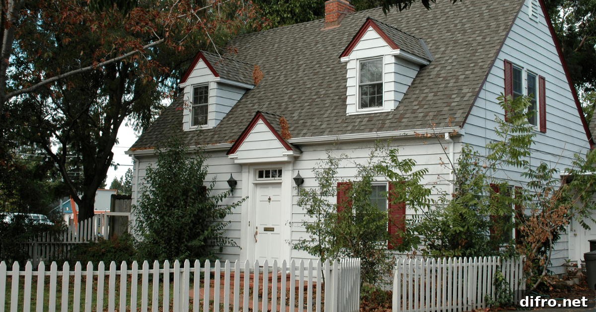 Cape Cod style house with white fencing.