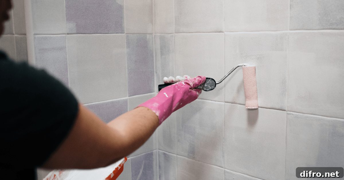 Person repainting tiles in a bathroom.