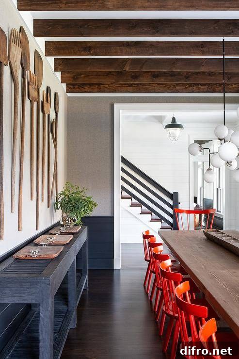 Large forks and spoons decorate a rustic farmhouse dining room wall.