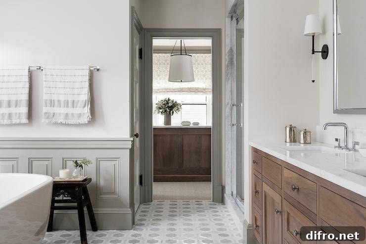 Gray wainscoting accents while walls and floors covered in gray marble hexagon floor tiles.