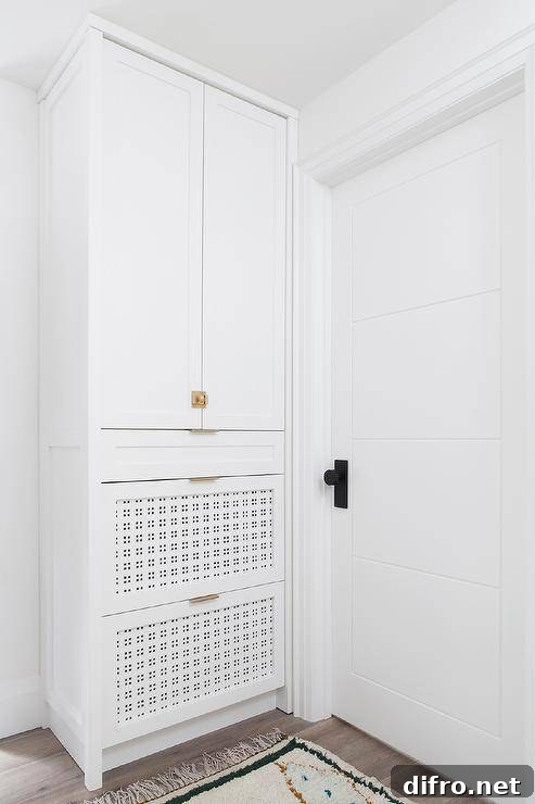 Built-in entry cabinets with pierced shoe drawers and vintage latch hardware.