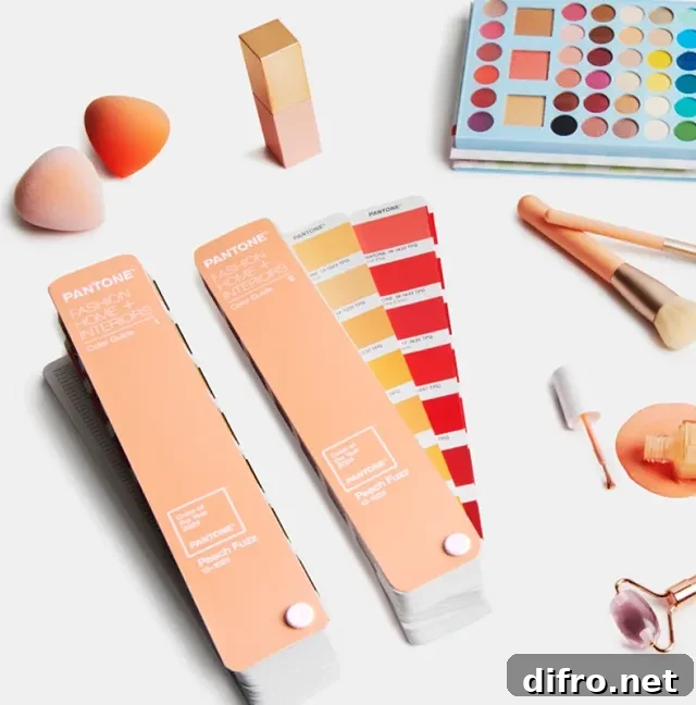 Makeup and beauty products laid out near a color palette that include Peach Fuzz 13-1023