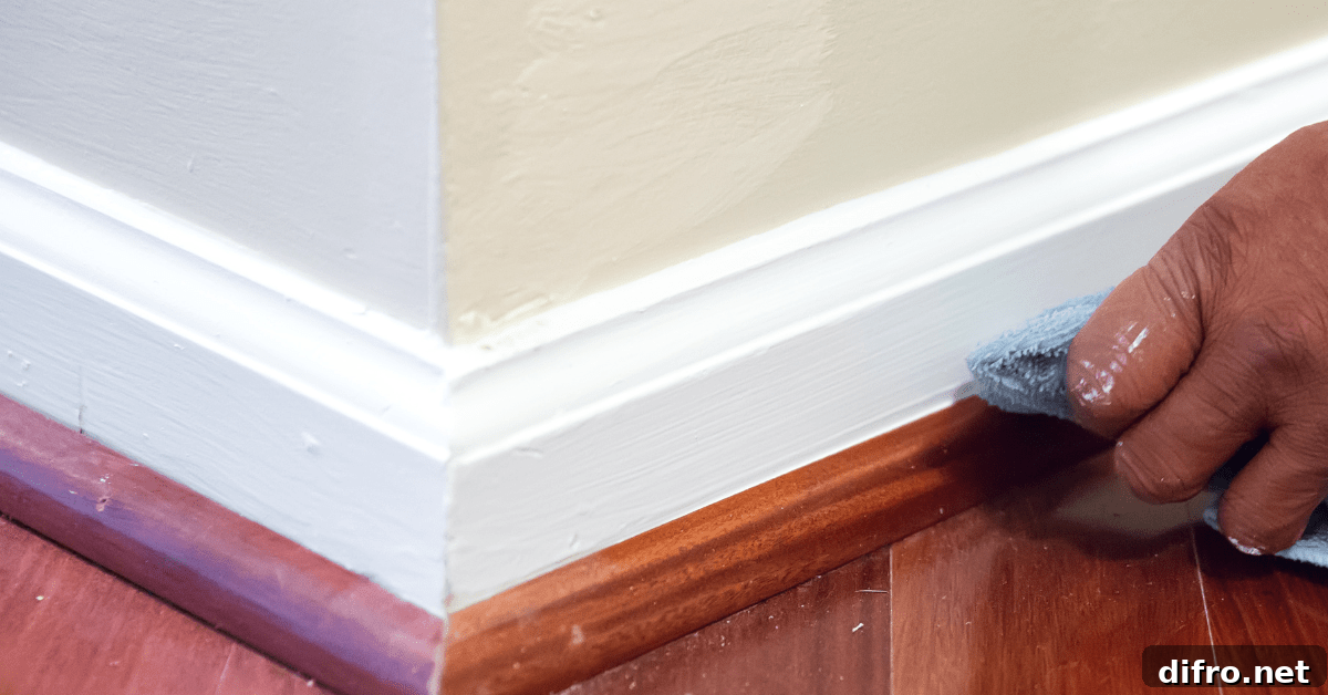 White baseboards being cleaning with microfiber.