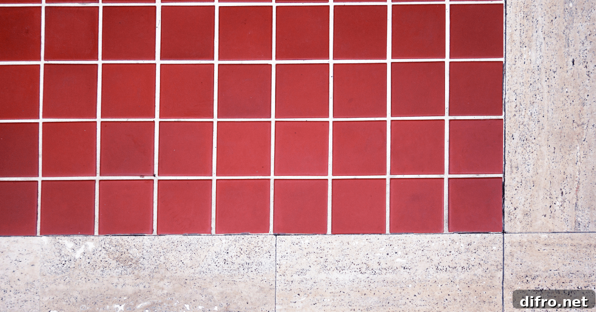 Red terracotta floor tiles surrounded by tile.