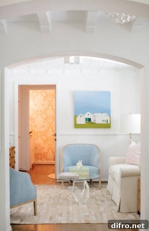 Formal living room with ivory linen sofa, blue velvet armchairs, and a hex lucite coffee table.