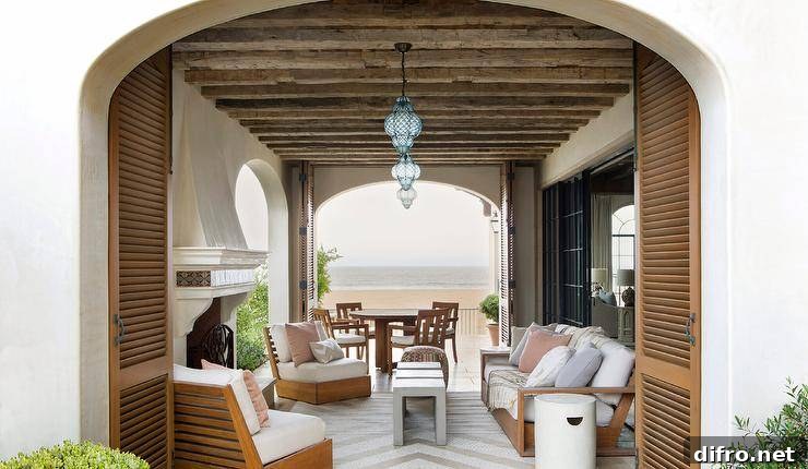 Ceiling Design Ideas to Add Personality to Your Home 7 Rustic wood ceiling beams accent a furnished covered patio lit by blue glass Moroccan lanterns.